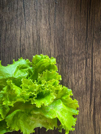 Fresh Lettuce on the wooden background and space for textの写真素材