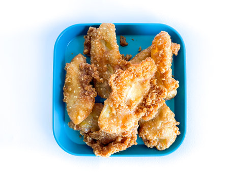 Deep-fried sliced banana ready to eat on the white backgroundの写真素材