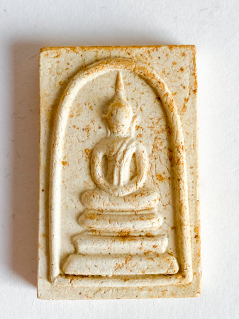 Thai old buddha amulet on white background.の写真素材