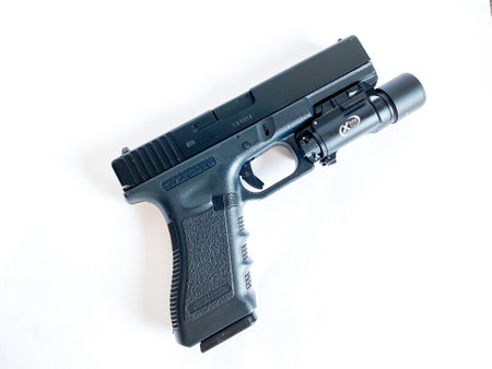 Bangkok Thailand - 21 March 2023: Air soft gun Glock 18C pistol gun with flashlight sight on the white backgroundのeditorial素材