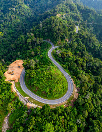 Road in the middle of the forest construction up to the mountainの素材