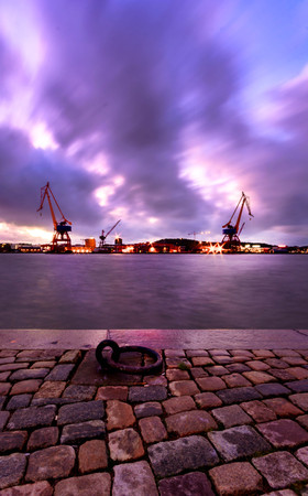 View with two loading cranes from Stenpiren bus terminal gothenburg sweden captured during stormのeditorial素材