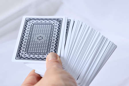 Tarot cards in hand on white background, closeup.の写真素材