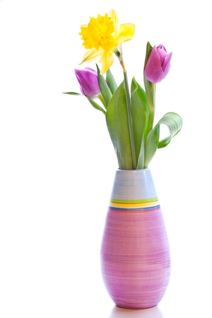 A bouquet of two tulips and narcissus in a vase isolated over white backgroundの写真素材