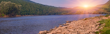 Sunrise on the river in the mountainsの写真素材
