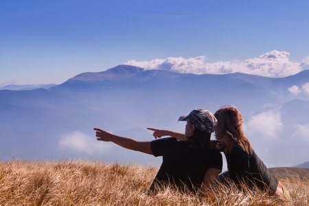 Two girls show the movement in the mountainsの写真素材
