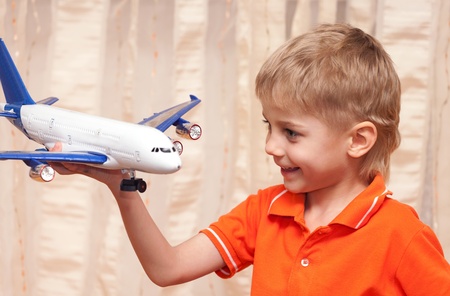 Adorable four year old boy playing with airplaneの写真素材