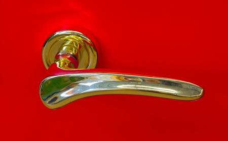golden door handle on a red backgroundの写真素材