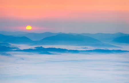 Sunrise over the sea of fog in the mountains at the summerの写真素材