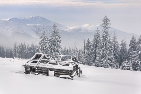 old farm in the mountains at winterの写真素材