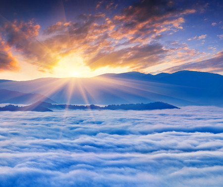 Sunrise over the sea of fog in the mountains at the summer