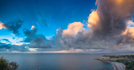 Evening cloudscape on the Milazzo cape, nature reserve Piscina di Venere, Sicily, Italy, Tyrrhenian sea, Europe.の写真素材