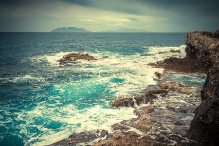 Stormy weather on the volcanic beach on nature reserve Piscina di Venere, cape Milazzo, Sicily, Italy, Mediterranean sea, Europe. Retro style.の写真素材