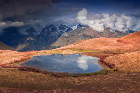 Colorful autumn morning on the lake Koruldi at the foot of Mt. Ushba. Upper Svaneti, Mestia, Georgia, Europe. Caucasus mountains. October 2015.の写真素材