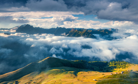 Sunny morning in the foggy Val di Fassa valley. View from passo Sella. Dolomite Alps, South Tyrol,...