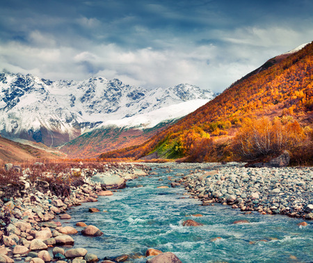 Southern foothills of mountain Shkhara. View from Ushguli village. Colorful autumn morning in Caucasus mountains, Upper Svaneti, Georgia, Europe. Artistic style post processed photo.の写真素材