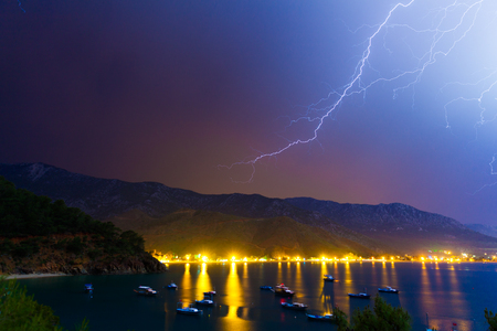 Lightning in the night sky under Adrasan bay. Adrasan village location, District of Kemer, Antalya Province, Turkey. Artistic style post processed photo.の写真素材