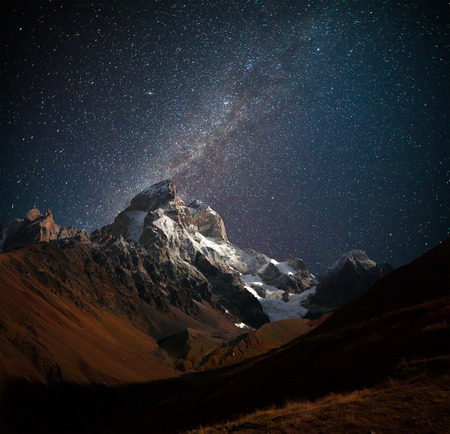 Night view of Ushba mountain with dark starry sky. Beautiful outdoor scene in the Caucasus mountains, Upper Svaneti, Europe.の写真素材