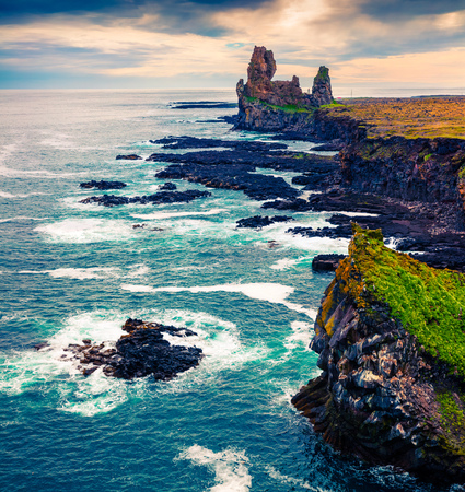 Dramatic summer day on Snafellsnes peninsula with Londrangar cliffs. Cloudy seascape on Atlantic ocean, situated to the west of Borgarfjordur, western Iceland, Europe. Artistic style post processed photo.の写真素材