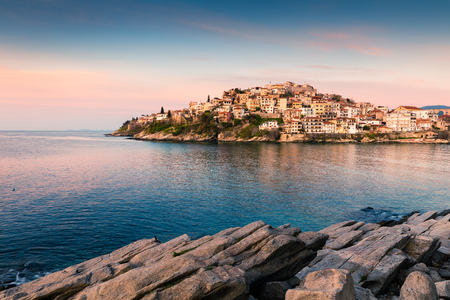 Sunny spring seascape on Aegean Sea. Coloful sunrise in Kavala city, the principal seaport of eastern Macedonia and the capital of Kavala regional unit. Greece, Europe.の写真素材