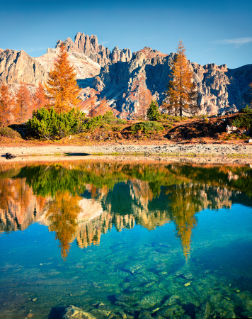 Splendid autumn view of Limides Lake. Colorful morning view of Dolomite Alps, Falzarego pass, Cortina d'Ampezzo lacattion, Italy, Europe. Beauty of nature concept background.