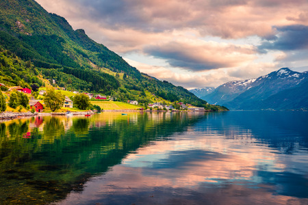 Picturesque summer sunrise in Lofthus village in Ullensvang municipality which is located in the Hardanger region of Hordaland county, Norway. Beauty of countryside concept background.の写真素材