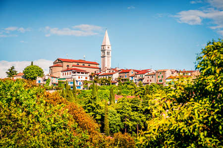 Bright view of small town Vrsar (Orsera) and St. Martin Catholic Church. Colorful spring cityscape...