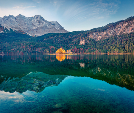 Picturesque morning scene of Eibsee lake with Zugspitze mountain range on background. Colorful...