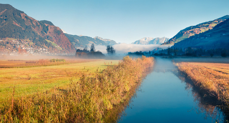 Sunny morning scene near Zell lake. Picturesque autumn view of Austrian Alps. Beauty of nature concept background.の写真素材