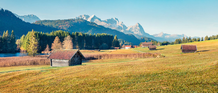 Captivating morning scene of Wagenbruchsee lake with Zugspitze mountain range on background. Panoramic autumn view of Bavarian Alps, Germany, Europe. Beauty of nature concept background.の写真素材