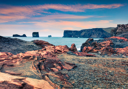 Great summer sunrise of Dyrholaey Nature Reserve. Colorful morning view of Dyrholaey arch, south coast of Iceland, Europe. Beauty of nature concept background.の写真素材