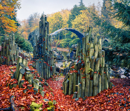 Mithtical morning view of Azalea and Rhododendron Park Kromlau, Germany, Europe. Splendid autumn scene of Rakotz Bridge (Rakotzbrucke, Devil's Bridge). Traveling concept background.の写真素材