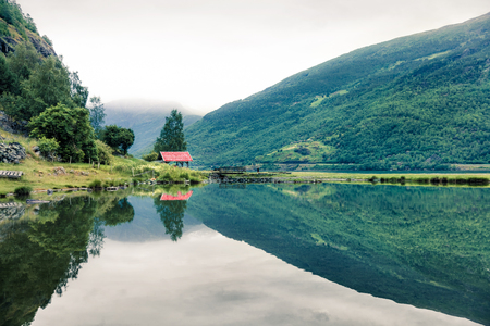 Beautiful summer view of Sognefjorden fjord. Green morning scene of Flom port, Norway. Beauty of nature concept background. Artistic style post processed photo.の写真素材
