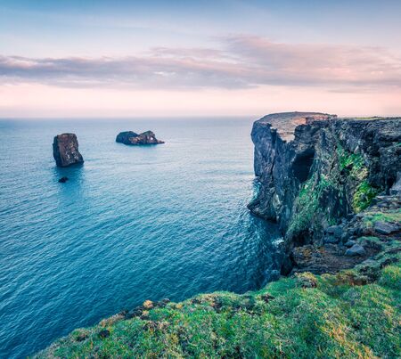 Beautiful evening view of Dyrholaey arch. Dramatic summer sunset in Dyrholaey Nature Reserv, south...