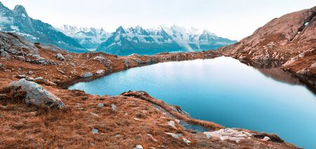 Breathtaking summer panorama of Lac Blanc lake with Mont Blanc (Monte Bianco) on background, Chamonix location. Beautiful outdoor scene of Graian Alps, France, Europe. Infrared filter toned.の写真素材