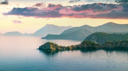 Few minutes before the sunrise on the Mediterranean sea in April. Colorful morning scene in the small bay near Tekirova village, District of Kemer, Antalya Province.の写真素材