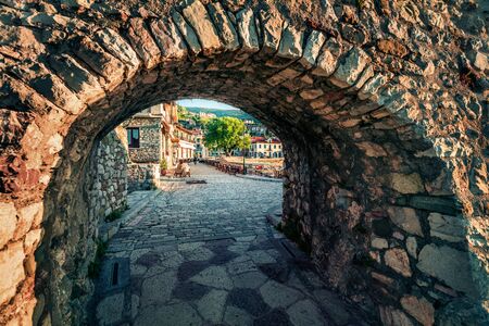 Picturesque spring view through the arch of Nafpaktos town. Beautiful morning scene of Greece small port, Europe. Traveling concept background.の写真素材