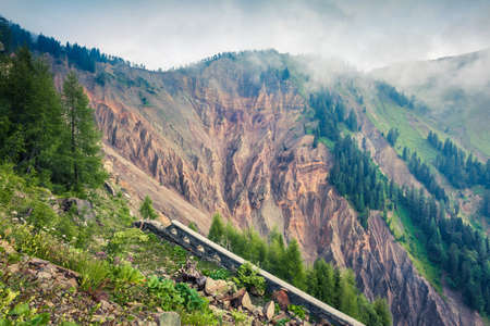 Ruins of old mountain road in dolomite Alps. Impressive morning scene in Italy. Misty summer landscape ot the high mountains. Traveling concept background.の写真素材