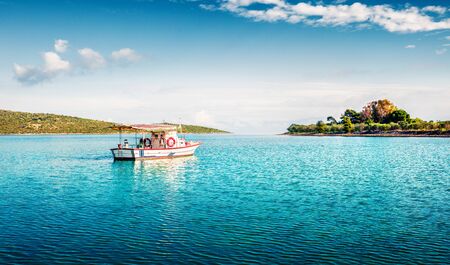Bright spring scene of small fishing town - Mikrovivos. Stunning morning seascape of Aegean sea....