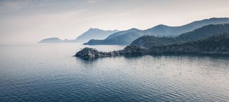 Early morning seascape of Mediterranean sea in April. Picturesque spring scene of small bay near...