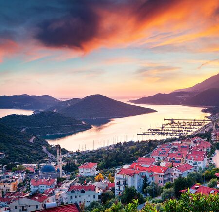 Dramatic spring view from the bird's eye of Kas city, district of Antalya Province of Turkey, Asia. Colorful spring sunset in small Mediterranean yachting and tourist town. Traveling concept background.の写真素材