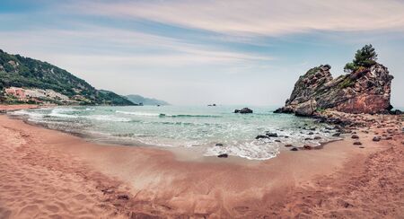 Panoramic spring view of Pelekas beach. Amazing morning seascape of Ionian Sea. Beautiful landscape of Corfu island, Kontogialos health resort, Greece, Europe. Traveling concept background.の写真素材