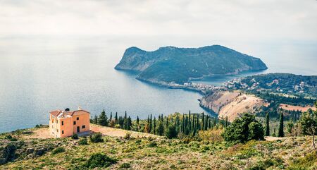 Misty spring view of Asos peninsula and town. Wonderful morning seascape of Ionian Sea. Amazing outdoor scene of Kephalonia island, Greece, Europe. Traveling concept background.の写真素材