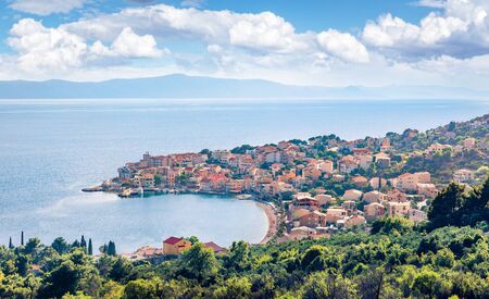 Misty morning cityscape of Igrane town, Croatia, Europe. Sunny summer seascape of Adriatic sea....