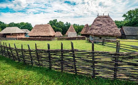 Stunning summer view of traditional romanian peasant houses. Bright rural scene of Transylvania, Romania, Europe. Beauty of countryside concept background.の写真素材