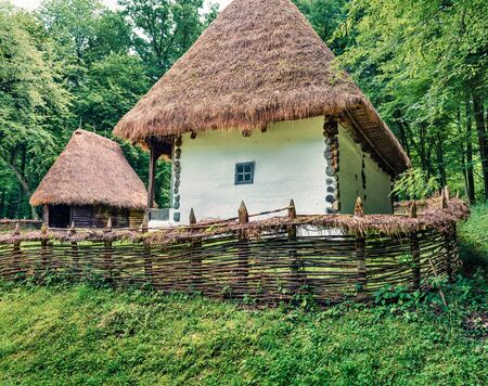 Captivating summer view of traditional romanian peasant houses. Nice rural scene of Transylvania, Romania, Europe. Beauty of countryside concept background.の写真素材