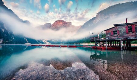 Foggy morning view of Braies (Pragser Wildsee) lake. Greaty summer sunrise in Fanes-Sennes-Braies national park, Dolomiti Alps, South Tyrol, Italy, Europe. Beauty of nature concept background.の写真素材