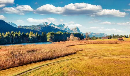 Sunny morning scene of Wagenbruchsee (Geroldsee) lake with Zugspitze mountain range on background. Beautiful autumn view of Bavarian Alps, Germany, Europe. Beauty of nature concept background.の写真素材