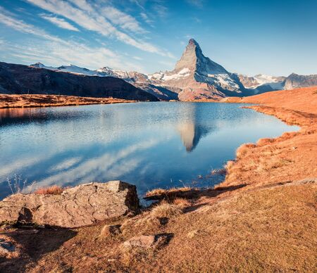 Amazing morning view of Stellisee lake with Matterhorn/Cervino peak on background. Attractive autumn scene of Swiss Alps, Zermatt resort location, Switzerland, Europe. Beauty of nature concept background.の写真素材