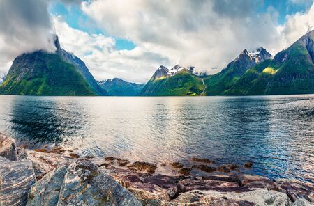 Impressive morning scene of Hjorundfjorden fjord, Orsta municipality, More og Romsdal county. Splendid summer view of Norway. Beauty of nature concept background.の写真素材